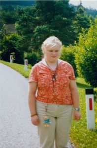 Eine junge Frau am Rand einer Landstraße stehend