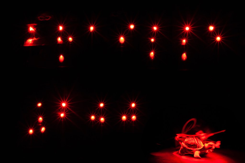 Die Punkte des Schriftzugs “Braille 200” (eben in Punktschrift) leuchten wie strahlende Sterne in der Dunkelheit. In der Mitte weiß, umgeben von einem innen orangefarbenen, außen roten Strahlenkranz. Das Wort “Braille” füllt die obere Bildhälfte. In der unteren steht links die Zahl “200”.